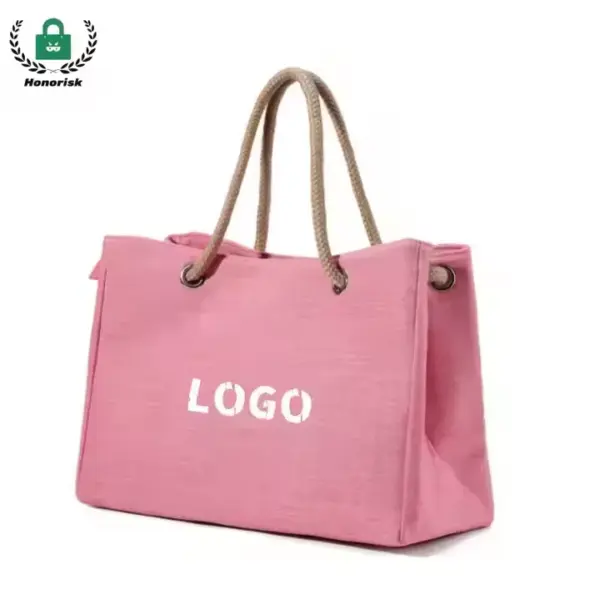 The Reusable Heavyweight Canvas Tote Bag features a pink design with rope handles and "LOGO" riba e parti dilanti, e ta disponibel pa personalisacion di OEM y ODM ..