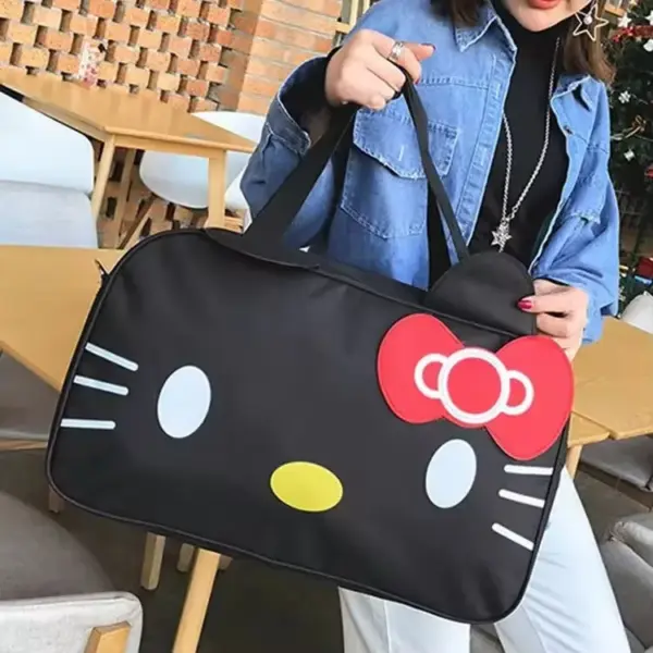 A person holds a large black Cute Cat-Themed Women's Travel Bag featuring a Hello Kitty face with a red bow and white whiskers—ideal for OEM/ODM customization.