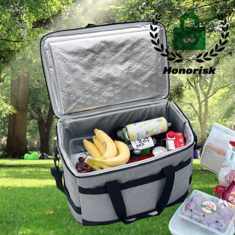 An Outdoor Zippered Picnic Tote in gray is open on grass in a park, holding fruit and drinks, with trees and a picnic scene in the background.