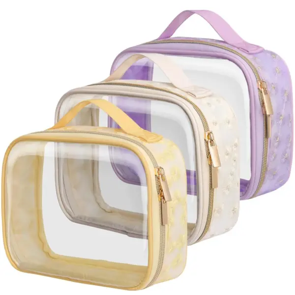 Set of three PVC Transparent Waterproof Makeup Bags with yellow, beige, and purple trim, floral embroidery, and handles. Each features a clear zippered design. OEM and ODM options available.