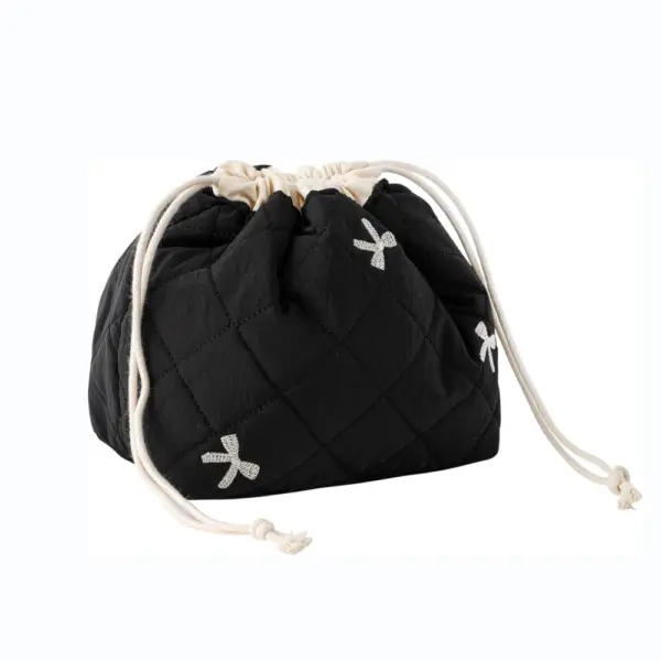 Cotton Drawstring Toiletry Bag—black quilted design with cream drawstrings and small white ribbon bows. OEM/ODM customization available.
