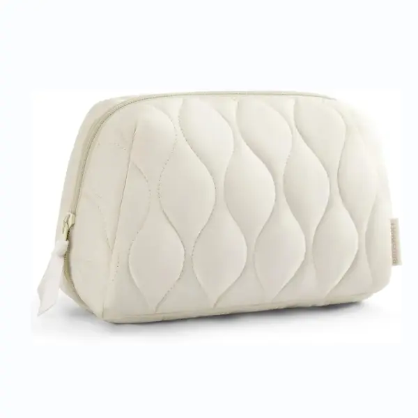 The Puffy Portable Makeup Bag is a cream-colored quilted pouch with a wavy pattern and zipper closure, available for OEM ODM customization.